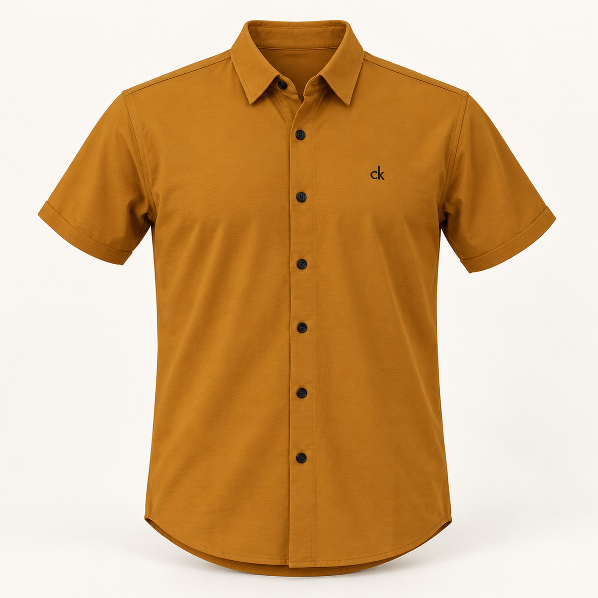Dimensional front product view of mustard short sleeve pocketless shirt with black buttons and small chest embroidery