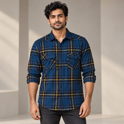 Adult model wearing navy yellow grey check full sleeve shirt with rolled sleeves and two flap pockets, front view