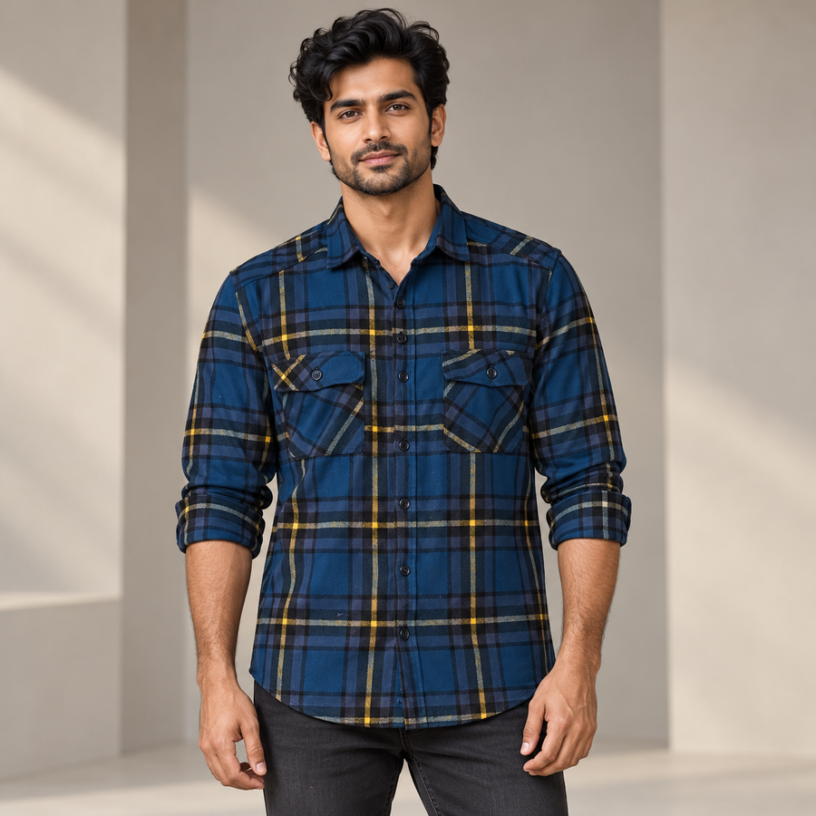 Adult model wearing navy yellow grey check full sleeve shirt with rolled sleeves and two flap pockets, front view