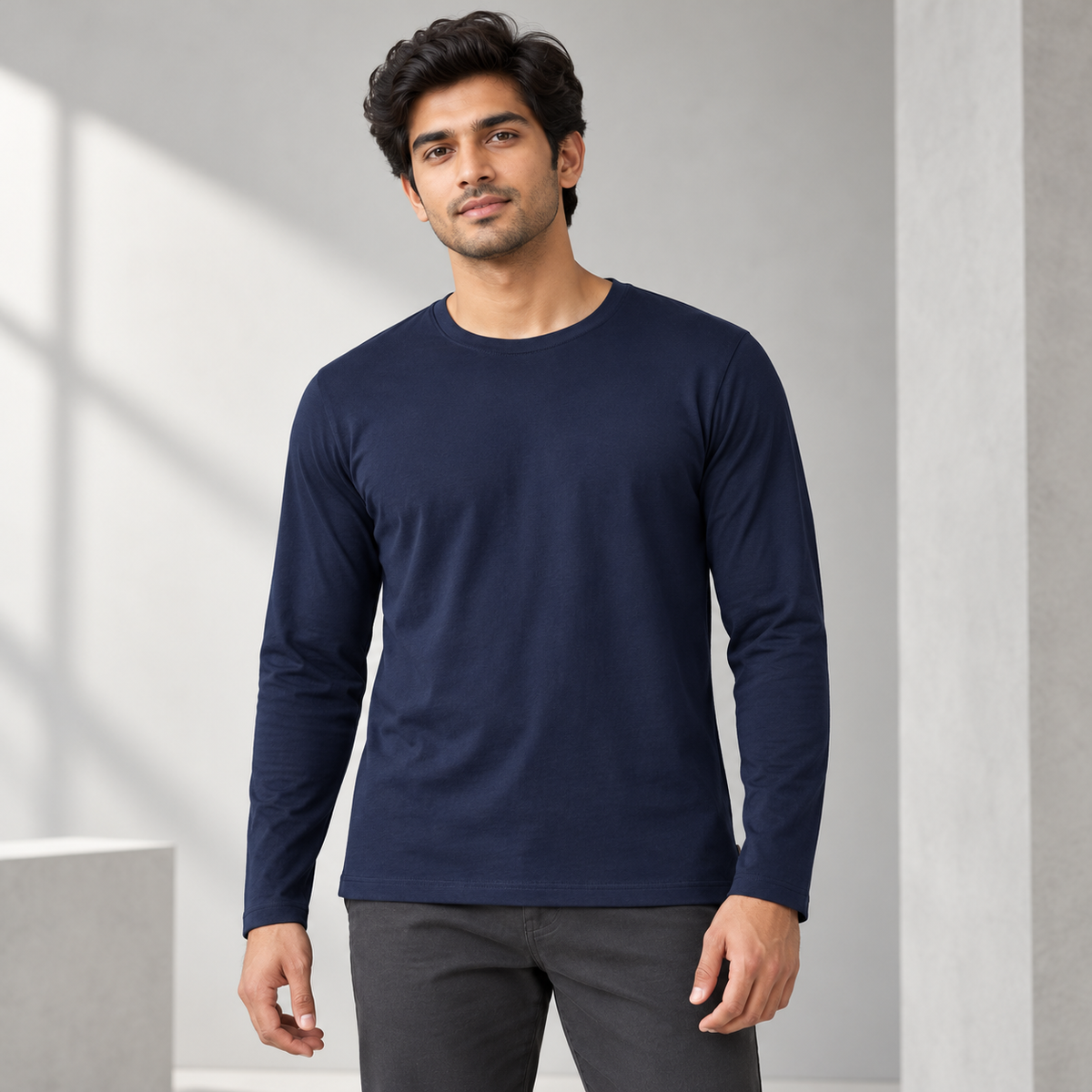 Plain navy long sleeve top on an adult male model.