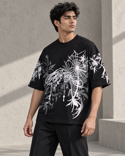 black floral spiderweb oversized T-shirt worn by a model, three-quarter front view